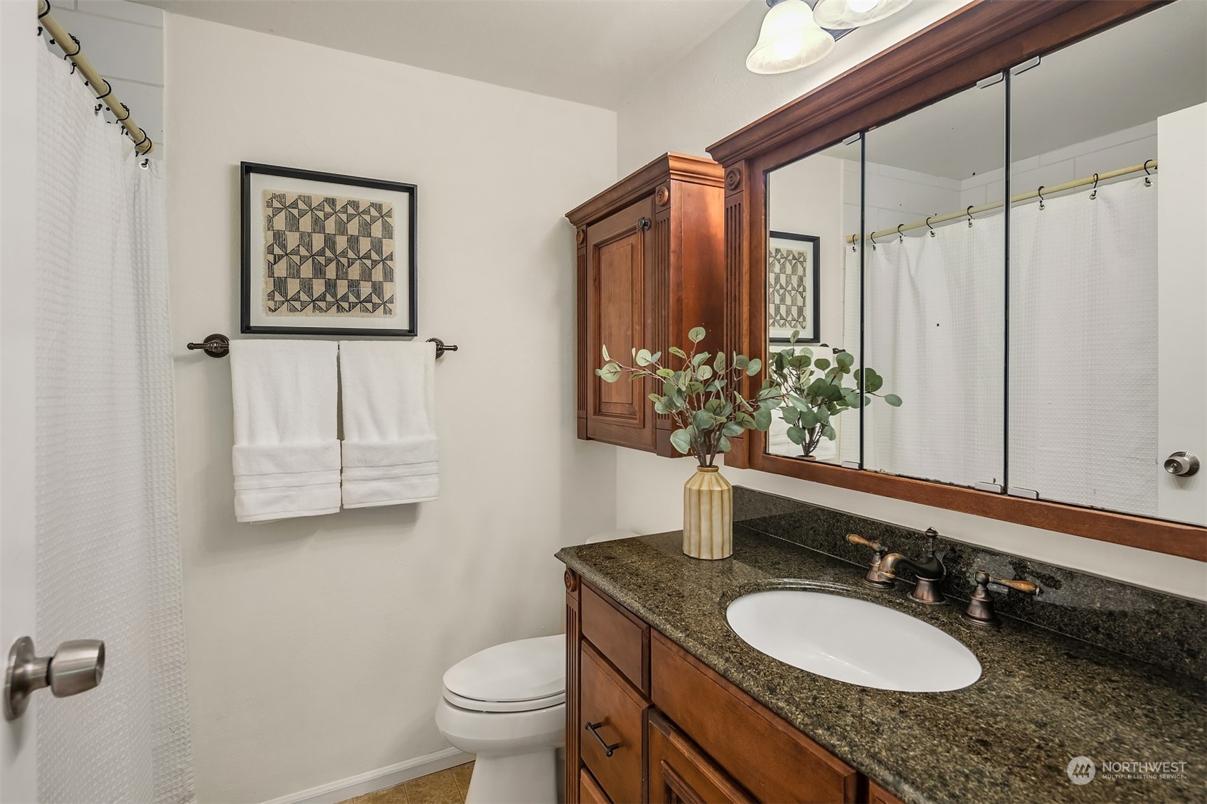 20211 Southeast 157th Street Renton, WA 98059 - Photo 17 of 38 a bathroom with a granite countertop sink toilet and mirror