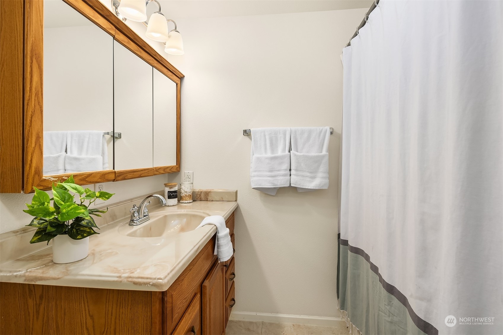20211 Southeast 157th Street Renton, WA 98059 - Photo 27 of 38 a bathroom with a sink a mirror and a shower