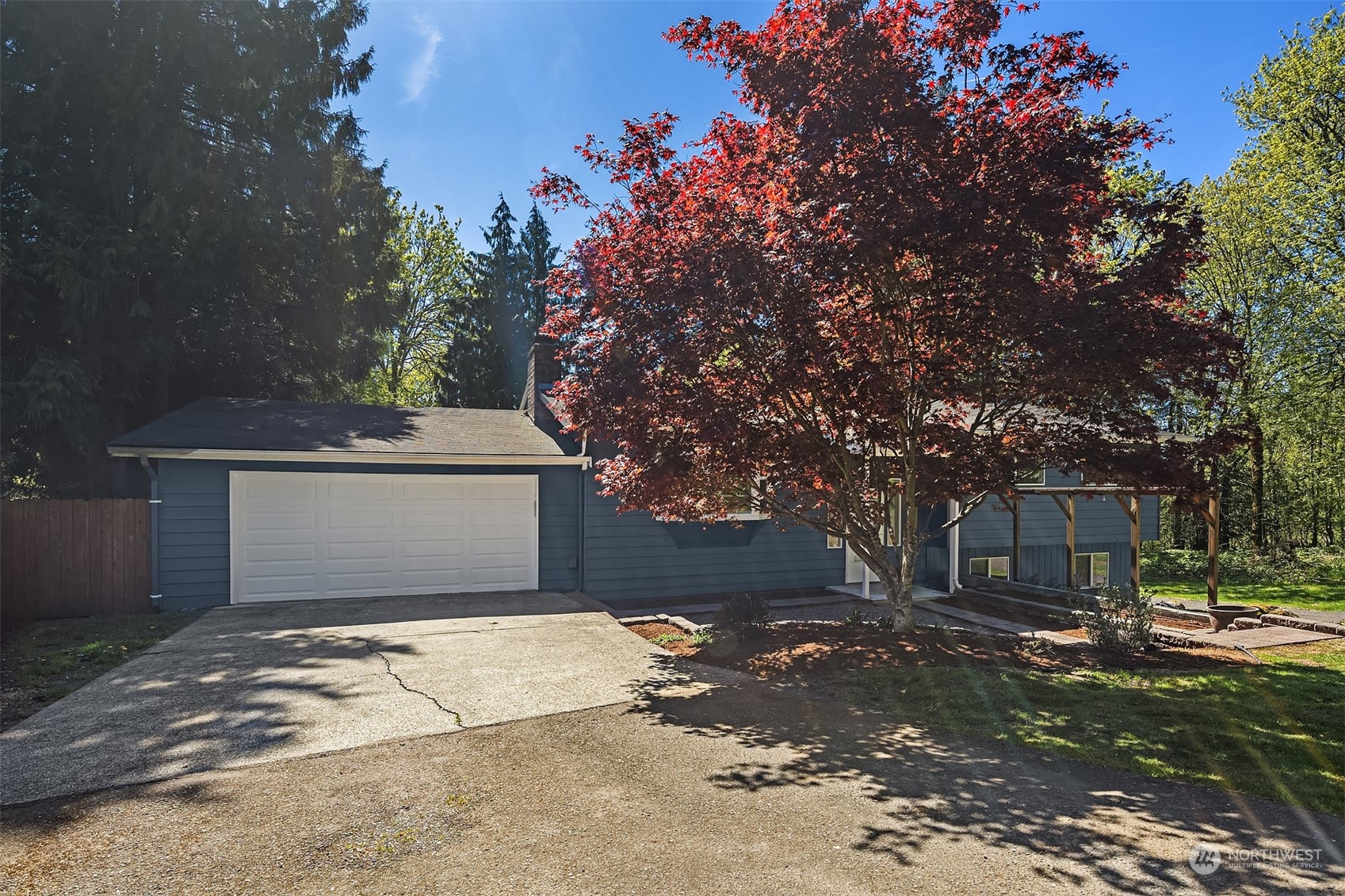 20211 Southeast 157th Street Renton, WA 98059 - Photo 37 of 38 a front view of a house with a yard and garage