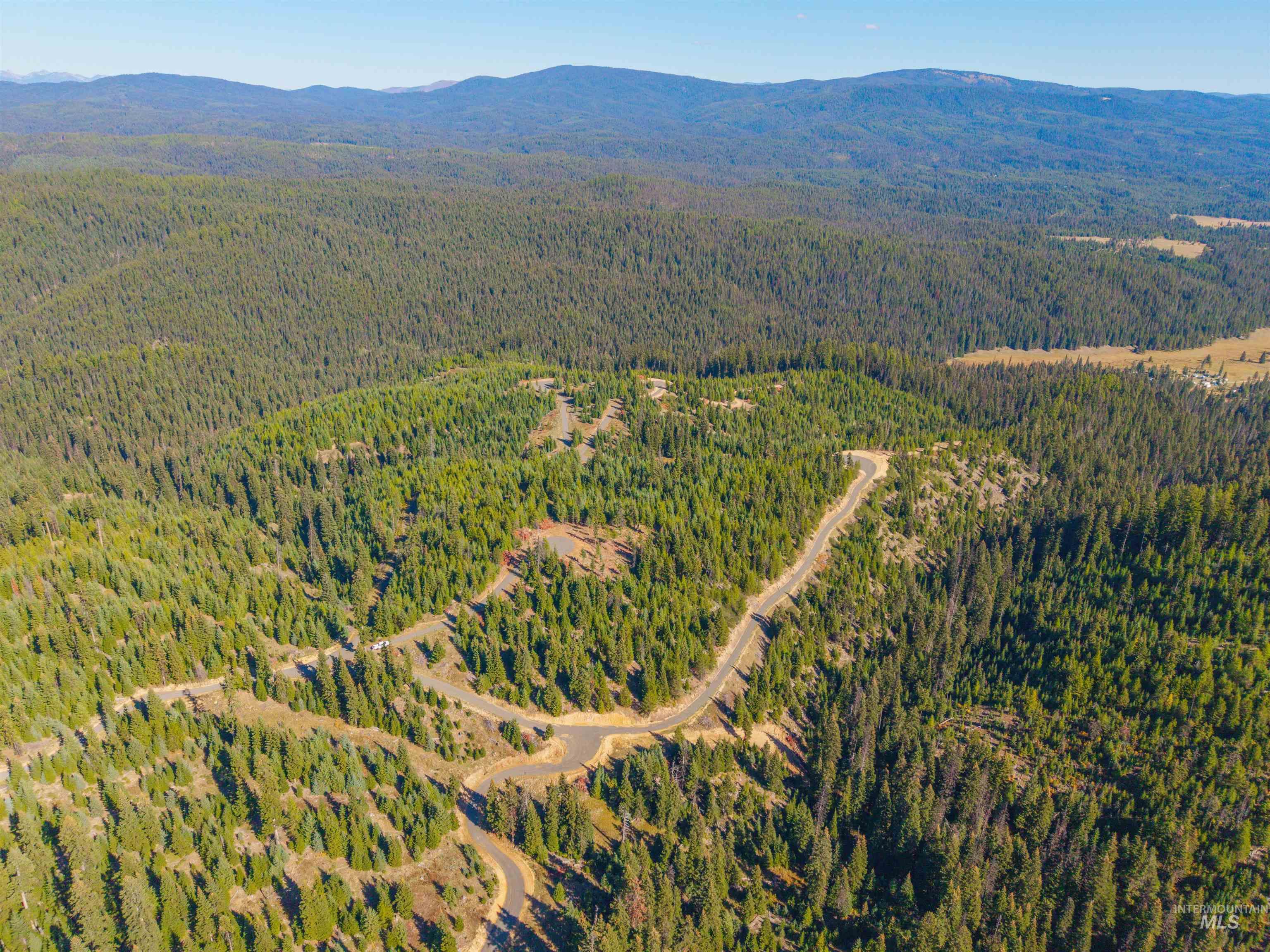 6 Tree Farm Trails Road Elk City, ID 83525 - Photo 8 of 13 Aerial view of property and surrounding area featuring a mountainous background