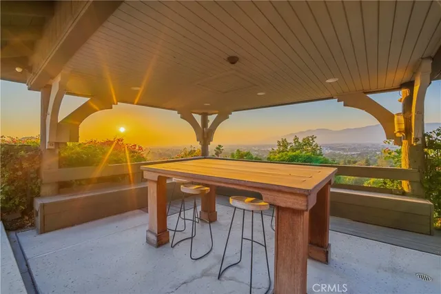 a view of a city with flower plants and wooden fence