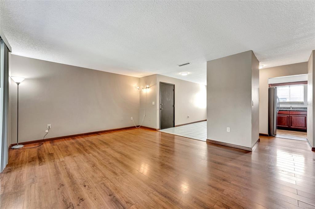 13300 Walsingham Road, Unit 56 Largo, FL 33774 - Photo 13 of 35 a view of an empty room with wooden floor and a window