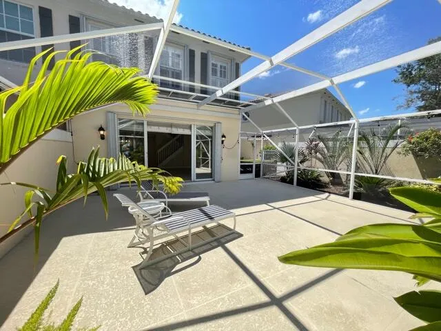 a view of a patio with a table and chairs