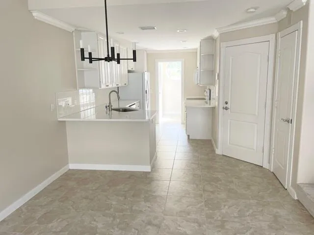 a view of a kitchen cabinets and a room