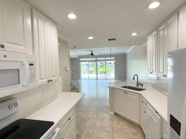 a kitchen with a sink stove and cabinets