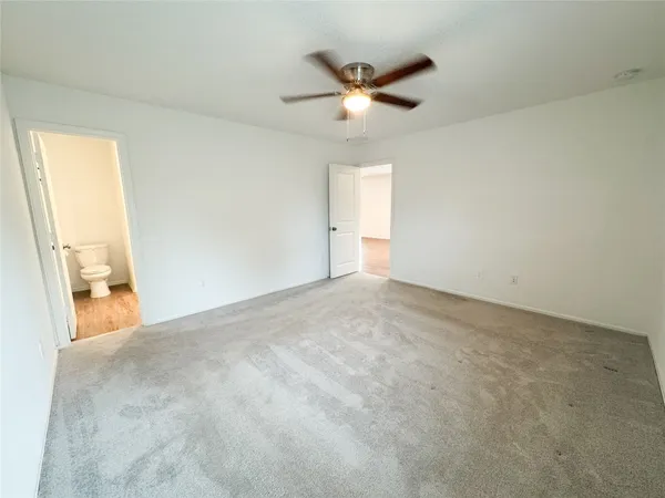 a view of a livingroom with a ceiling fan and window