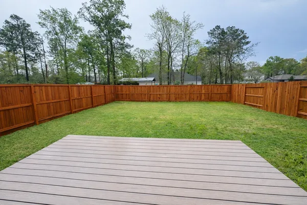 a view of a backyard with a wooden fence