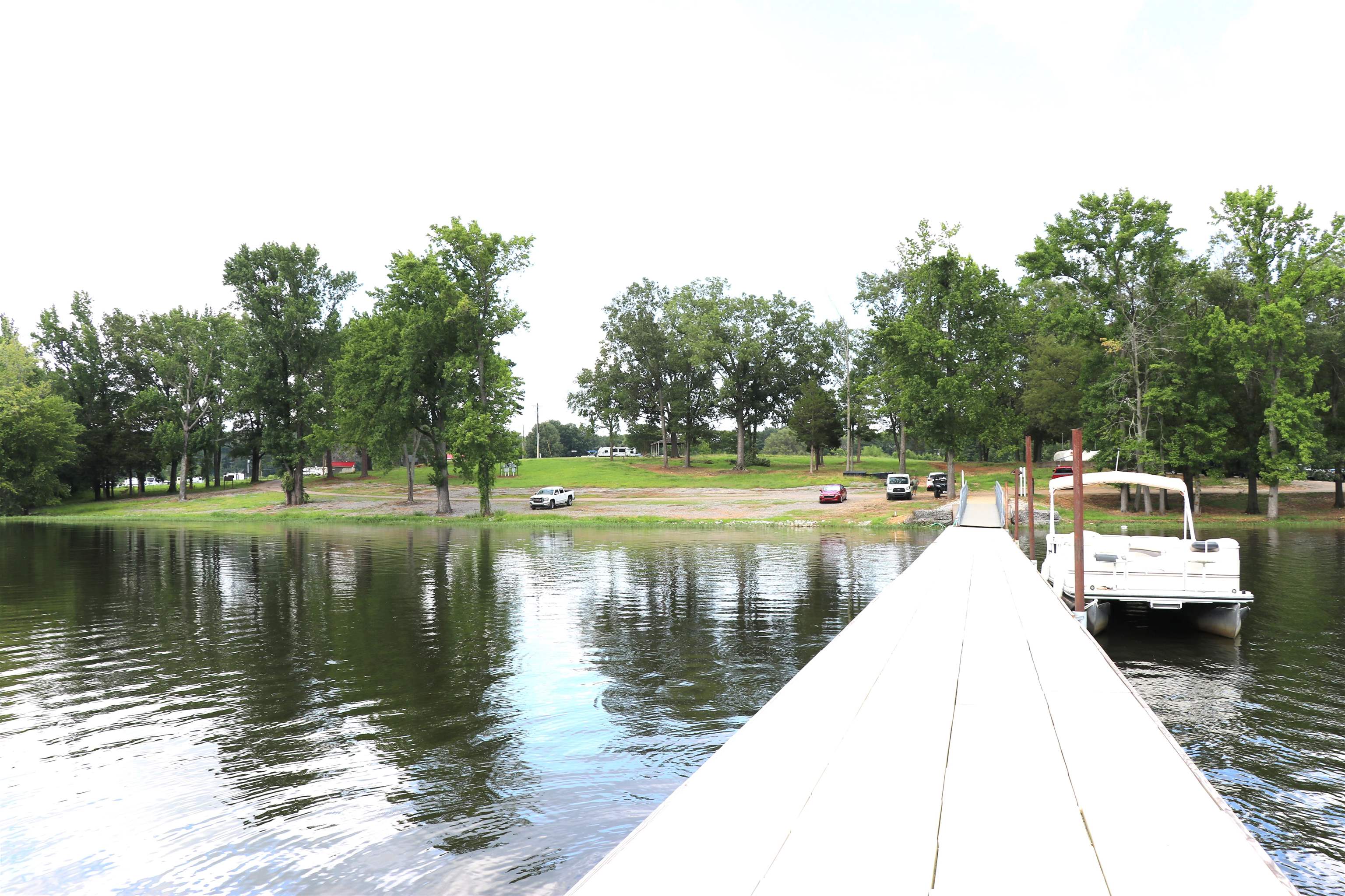 160 Patrick Drive Springville, TN 38256 - Photo 21 of 34 Private dock extending over calm water, featuring a moored boat and shoreline access
