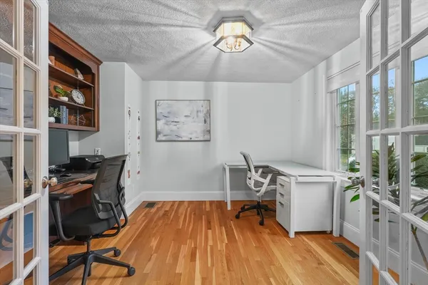 a view of a workspace with furniture and a window