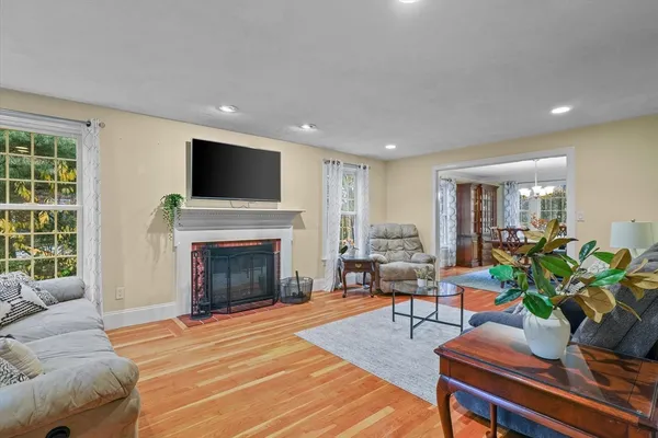 a living room with furniture a fireplace and a flat screen tv