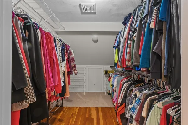 a view of walk in closet with clothes