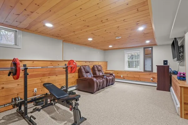 a bed room with furniture and a flat screen tv