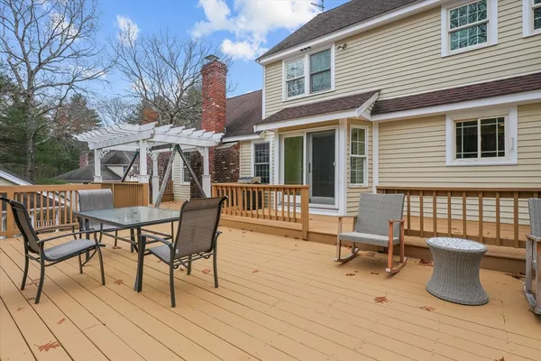 a view of a patio with table and chairs and wooden floor