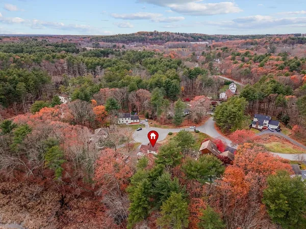 an aerial view of a house with a yard