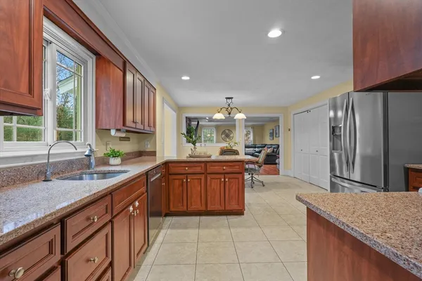a kitchen with stainless steel appliances granite countertop a sink counter space cabinets and a large window