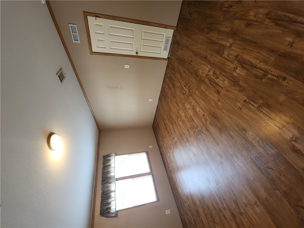 3738 Smetana Road Bryan, TX 77807 - Photo 11 of 29 an empty room with wooden floor and windows