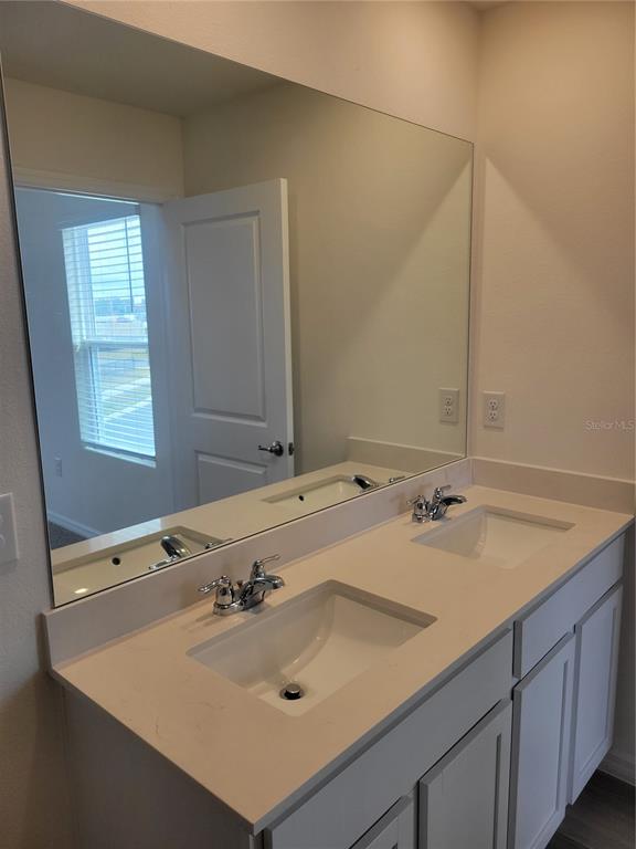 6534 Southwest 82nd Loop Ocala, FL 34476 - Photo 12 of 13 a bathroom with a sink and a mirror