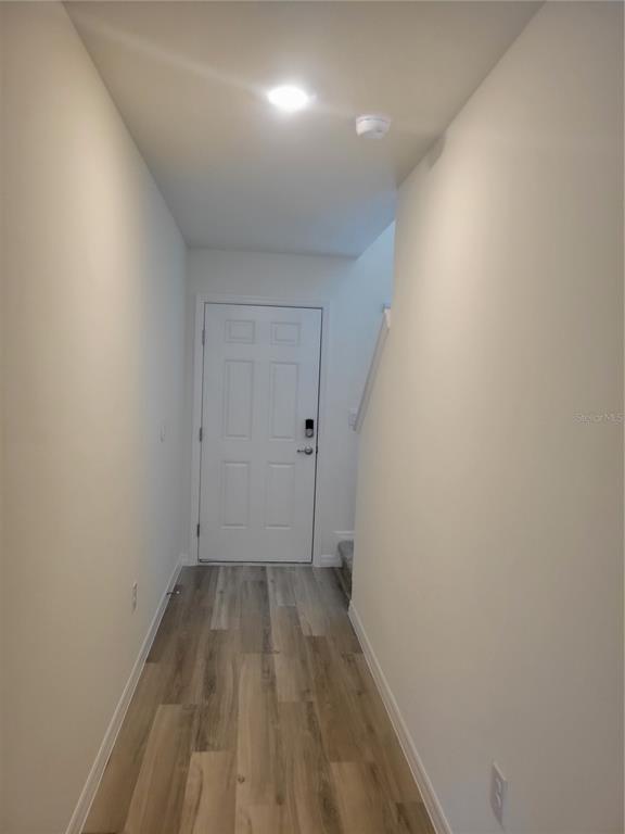 6534 Southwest 82nd Loop Ocala, FL 34476 - Photo 2 of 13 a view of room with wooden floor