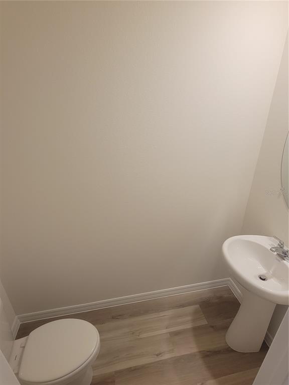 6534 Southwest 82nd Loop Ocala, FL 34476 - Photo 6 of 13 a white toilet sitting next to a white sink