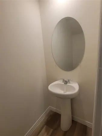 a bathroom with a sink toilet and a mirror
