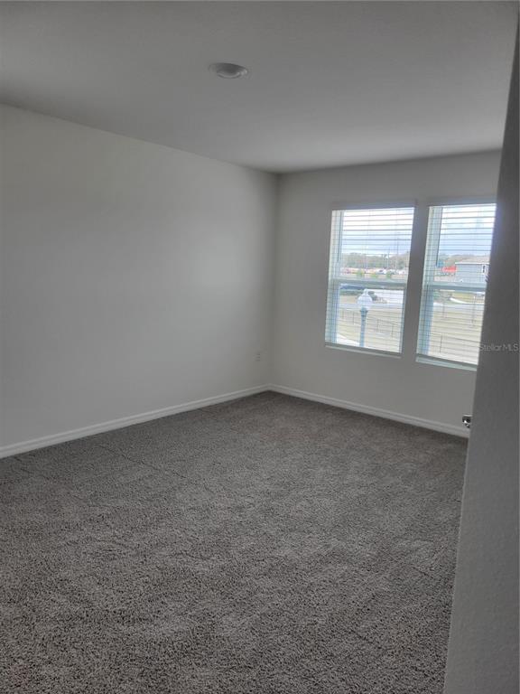 6534 Southwest 82nd Loop Ocala, FL 34476 - Photo 9 of 13 an empty room with a window