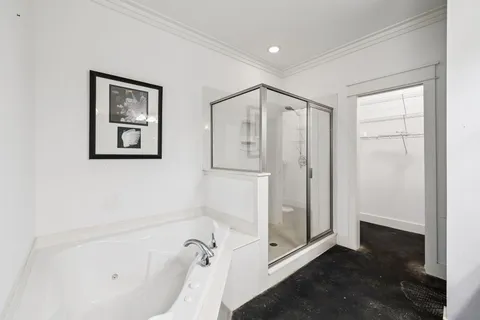 a bathroom with a granite countertop sink a large mirror and a shower