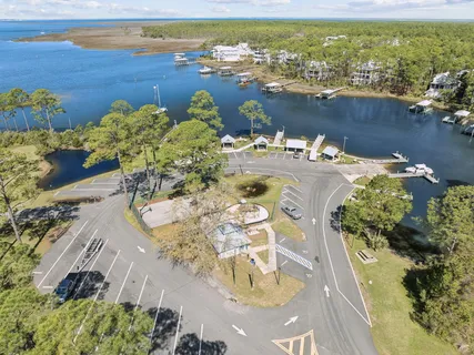 a view of a lake with boats and trees in the background
