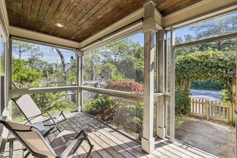 a view of a porch with furniture and wooden floor