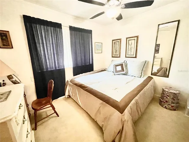 a bedroom with a bed and a large mirror