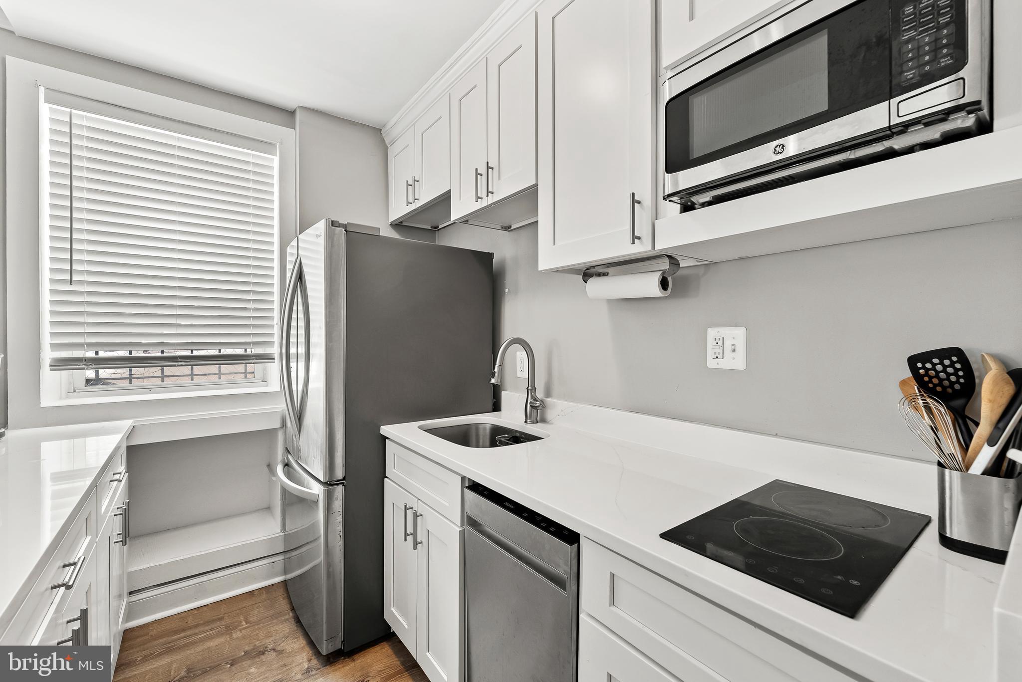 115 2nd Street Northeast, Unit 16 Washington, DC 20002 - Photo 6 of 21 a kitchen with stainless steel appliances white cabinets and a stove