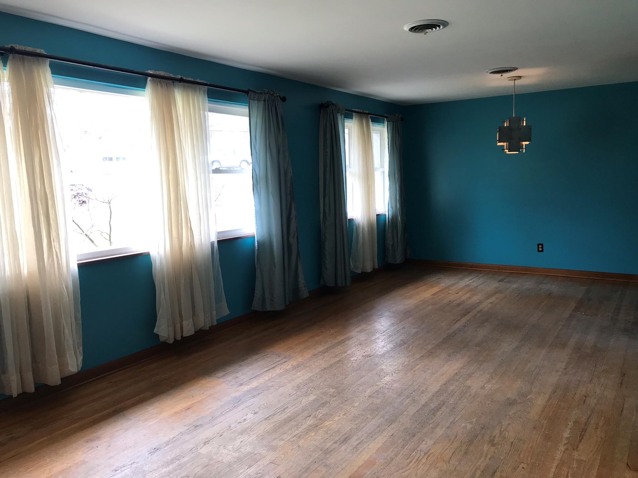 150 North Seneca Road Oak Ridge, TN 37830 - Photo 3 of 23 an empty room with wooden floor and windows