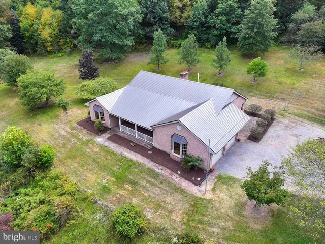 a backyard of a house with table and chairs with wooden fence