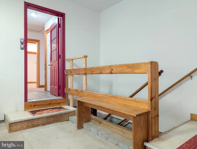 a view of an empty room with a fireplace and windows