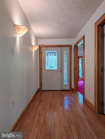a view of a area with flowers and wooden fence