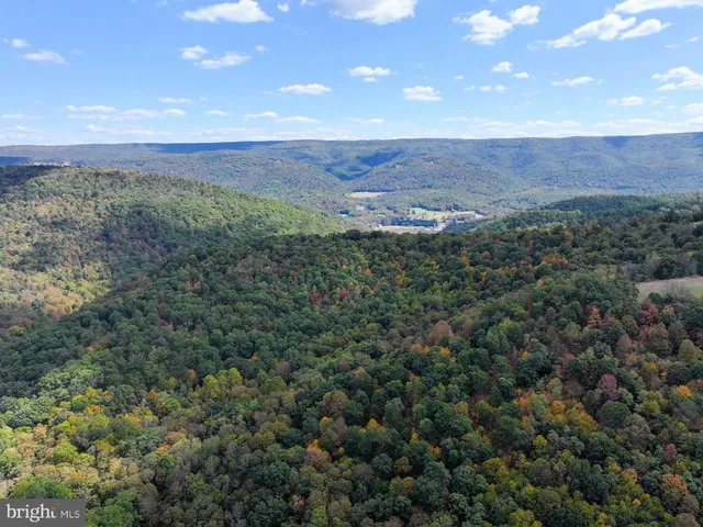 an aerial view of a house with big yard