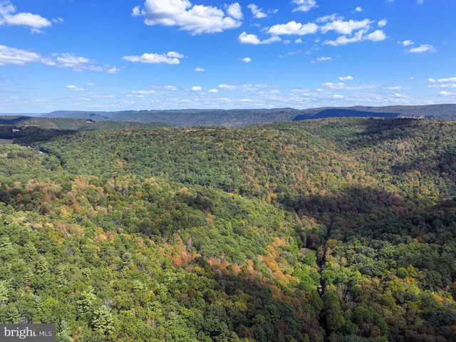 an aerial view of a house with garden space and lake view