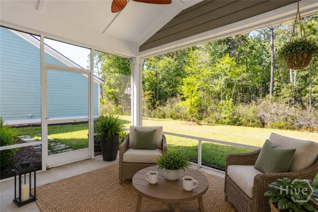 136 Binscombe Lane Pooler, GA 31322 - Photo 26 of 41 Screen Porch. *This photo has been virtually staged to illustrate the home's design possibilities and room functionality. Furnishings and decor shown are digital renderings and are not included with the property.