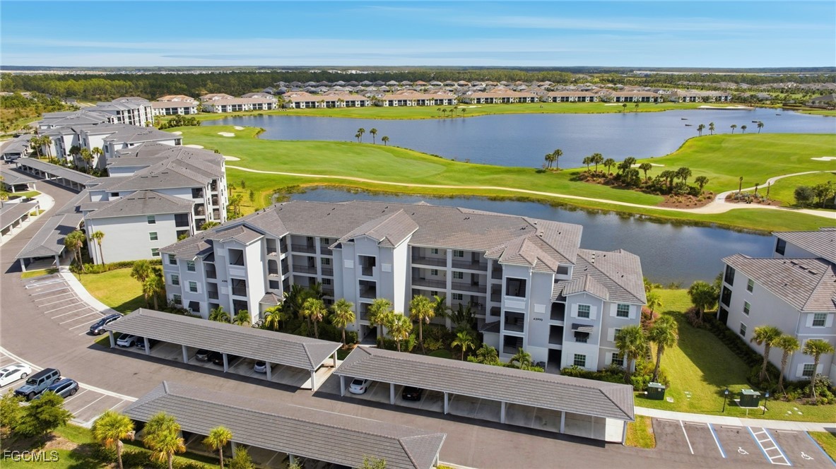 an aerial view of residential houses with outdoor space and ocean view