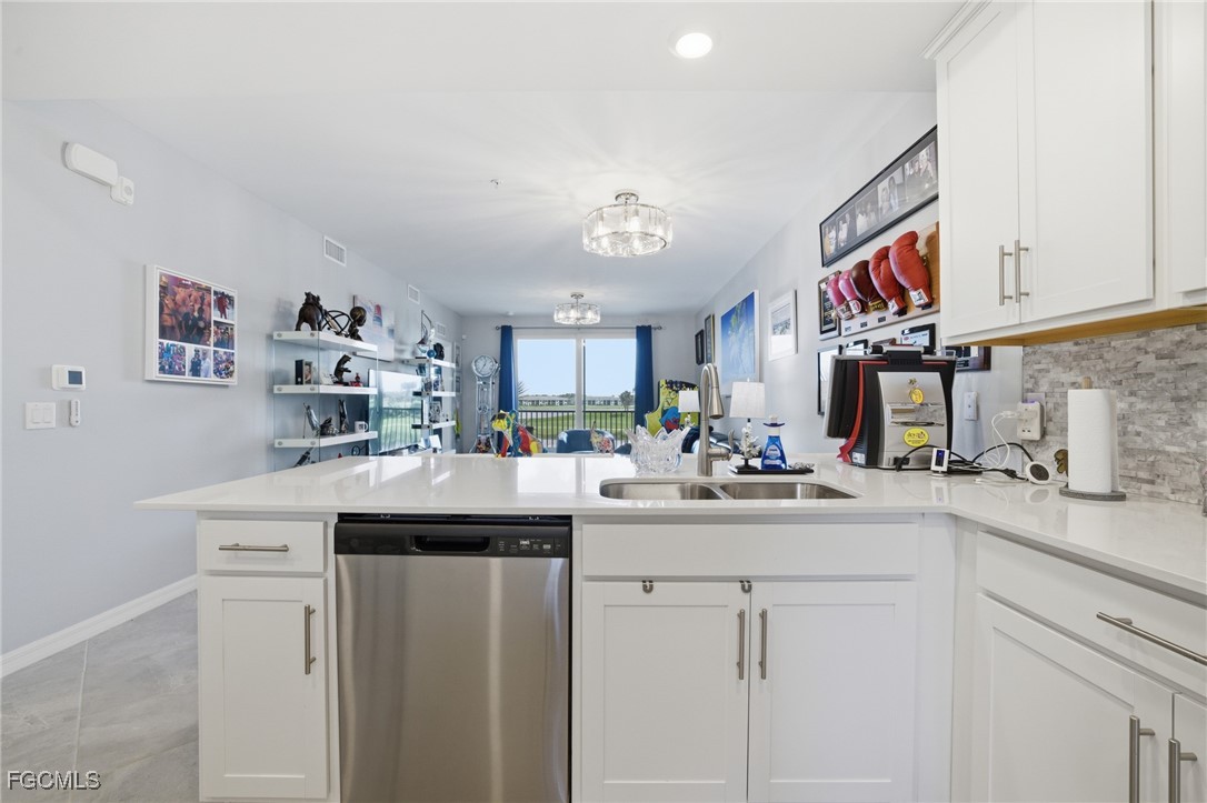 43993 Boardwalk Loop, Unit 1925 Punta Gorda, FL 33982 - Photo 11 of 35 a kitchen with cabinets a sink and appliances