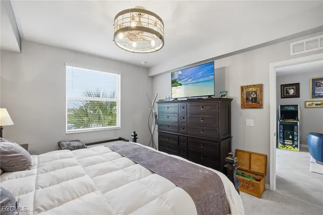 a bedroom with a bed and a chandelier