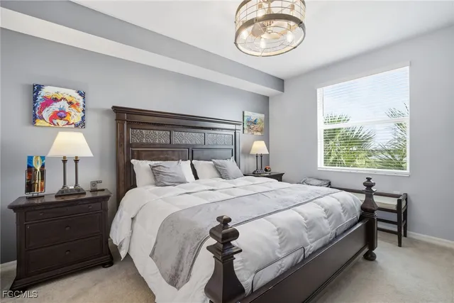 a bedroom with a bed and a chandelier
