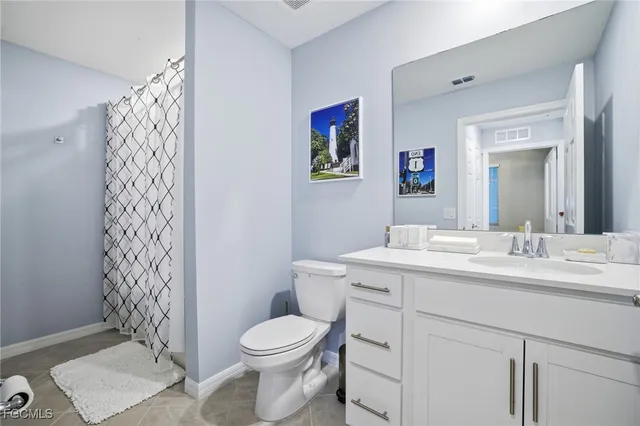 a view of bathroom with a toilet sink and mirror