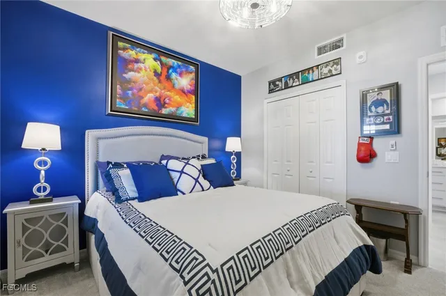 a bedroom with a bed and a painting on the wall