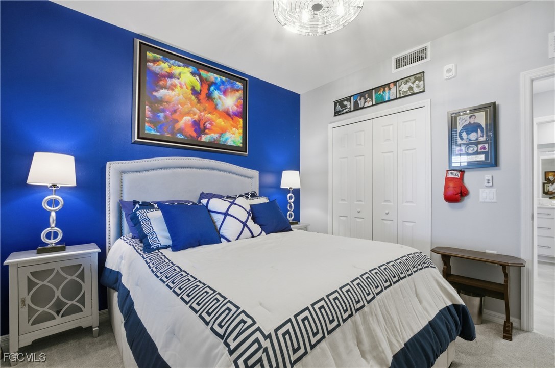 43993 Boardwalk Loop, Unit 1925 Punta Gorda, FL 33982 - Photo 19 of 35 a bedroom with a bed and a painting on the wall