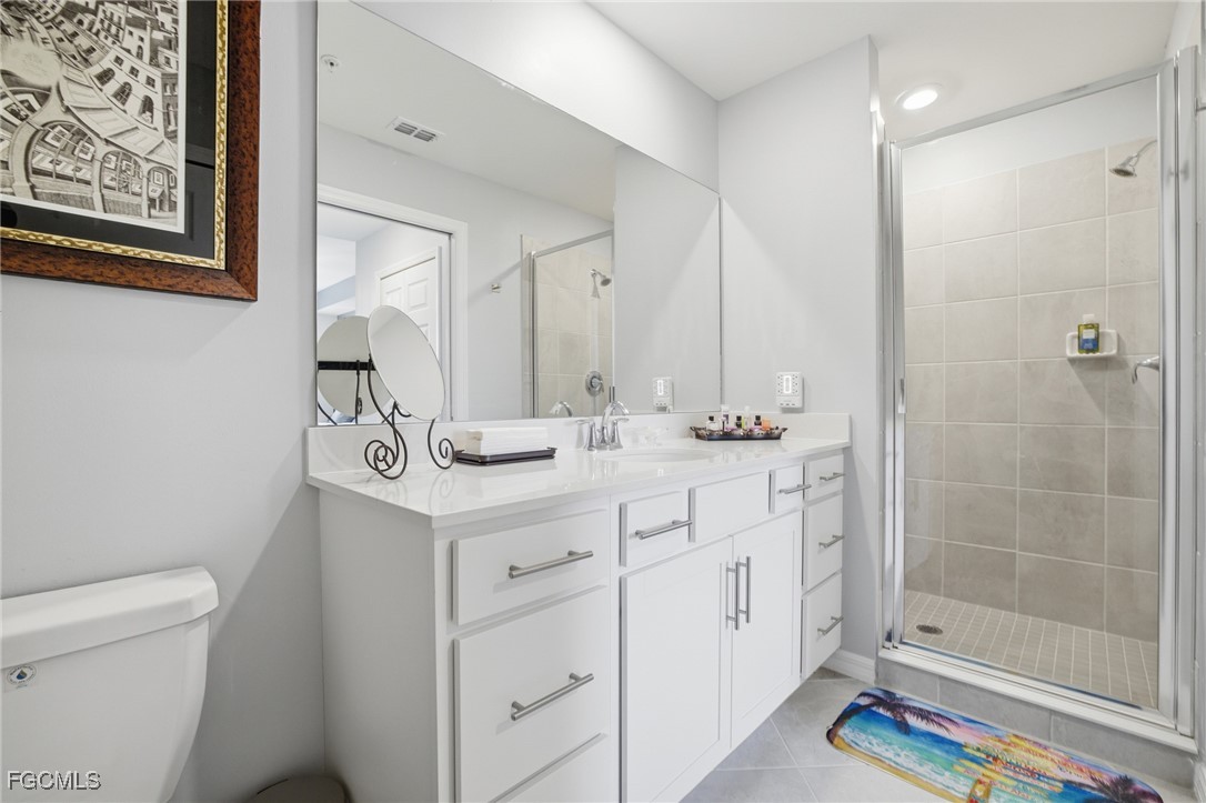 43993 Boardwalk Loop, Unit 1925 Punta Gorda, FL 33982 - Photo 21 of 35 a bathroom with a sink a toilet and shower