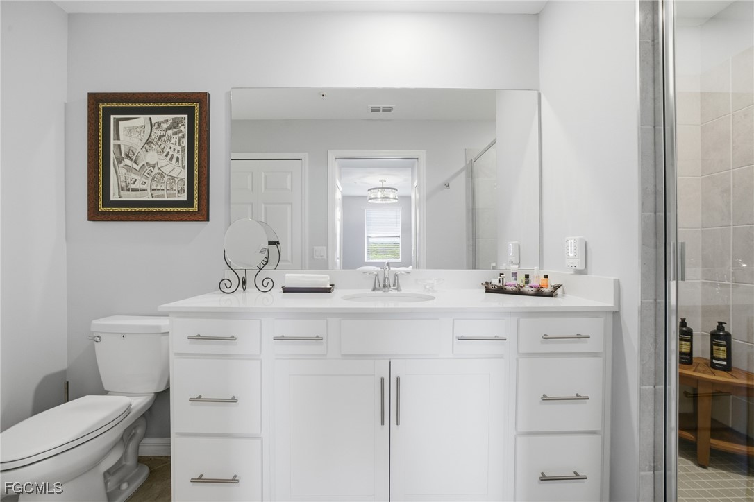 43993 Boardwalk Loop, Unit 1925 Punta Gorda, FL 33982 - Photo 22 of 35 a bathroom with a toilet a sink and mirror