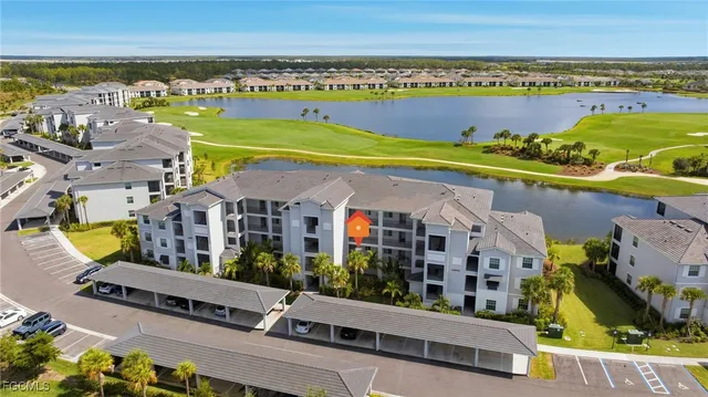 an aerial view of residential houses with outdoor space and ocean view