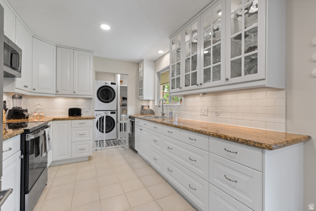 3320 Cherokee Lane Provo, UT 84604 - Photo 11 of 52 Kitchen featuring white cabinetry, light-toned countertops, subway tile backsplash, stainless steel appliances, and tile flooring