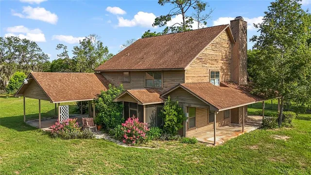 a house with green field in front of it