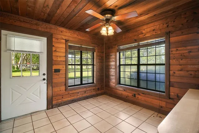 an empty room with closet and a chandelier fan